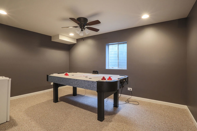 2639 Saltmeadow Road Naperville, IL 60564 - Photo 20 of 25 a room with chandelier fan and windows