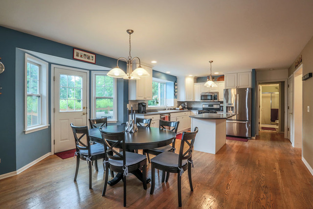 2639 Saltmeadow Road Naperville, IL 60564 - Photo 5 of 25 a view of a dining room and livingroom with furniture wooden floor a chandelier