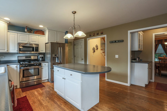 2639 Saltmeadow Road Naperville, IL 60564 - Photo 6 of 25 a kitchen with stainless steel appliances kitchen island granite countertop a stove refrigerator and microwave