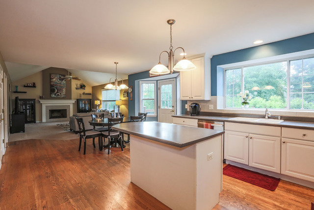 2639 Saltmeadow Road Naperville, IL 60564 - Photo 7 of 25 a kitchen with stainless steel appliances granite countertop a stove and a wooden floors