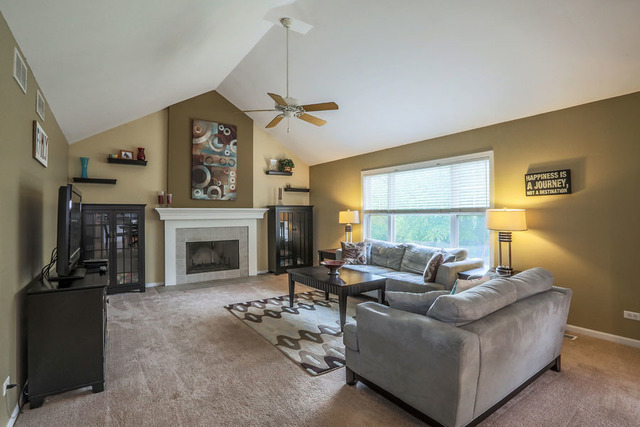 2639 Saltmeadow Road Naperville, IL 60564 - Photo 10 of 25 a living room with furniture and a fireplace