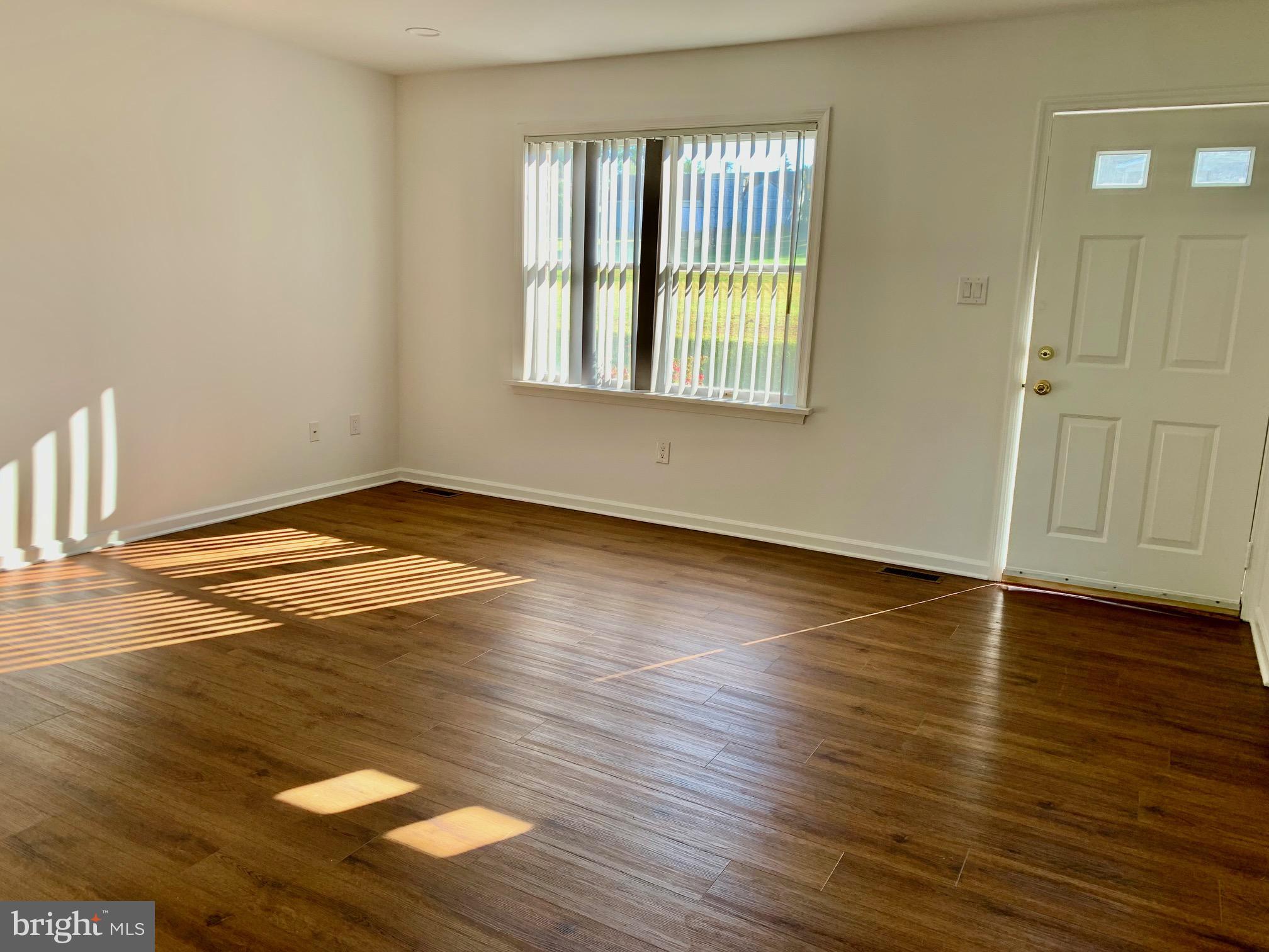 1029 North York Road Road, Unit D Willow Grove, PA 19090 - Photo 3 of 12 an empty room with wooden floor and windows