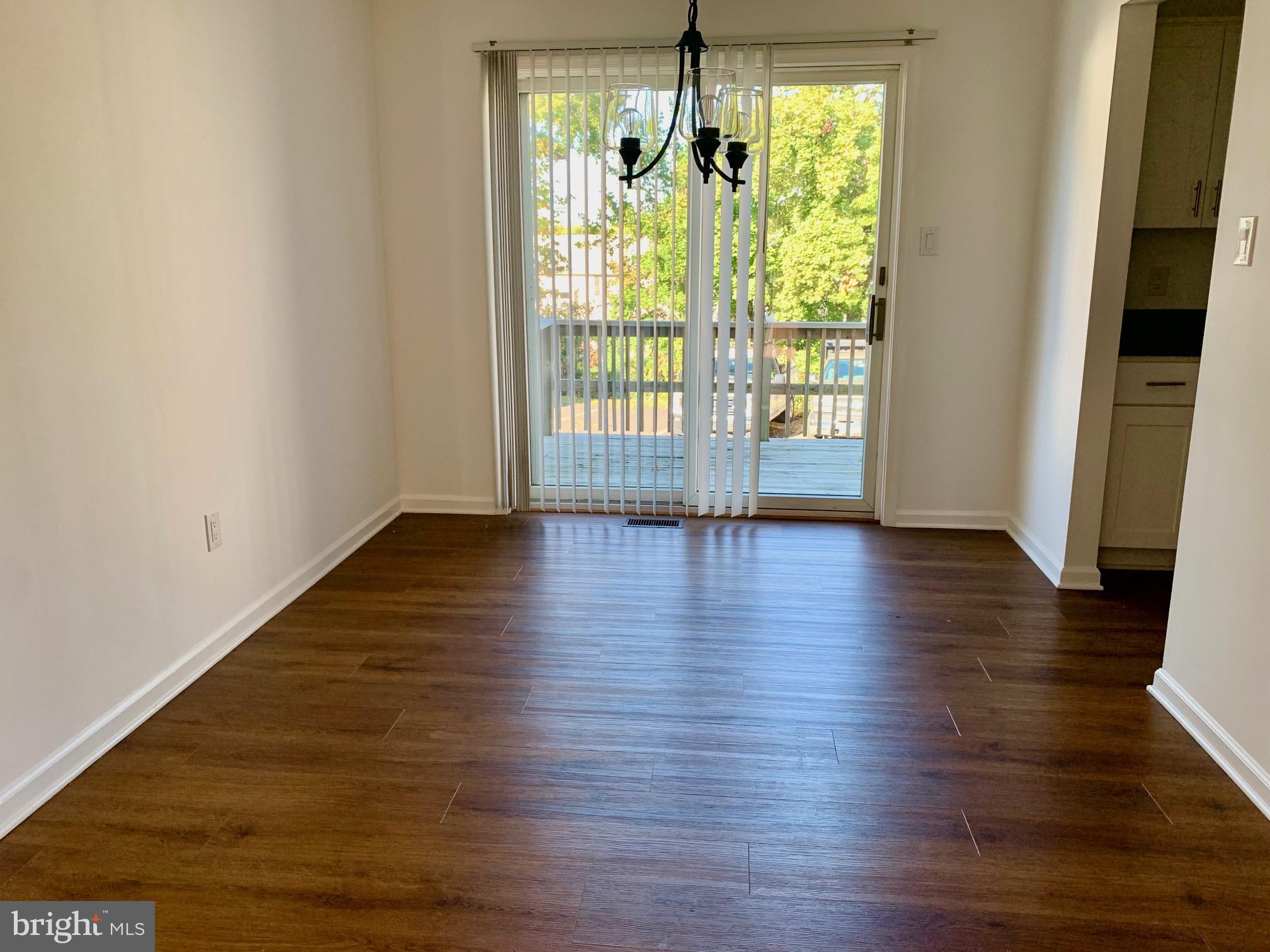 1029 North York Road Road, Unit D Willow Grove, PA 19090 - Photo 4 of 12 a view of an empty room with wooden floor and a window