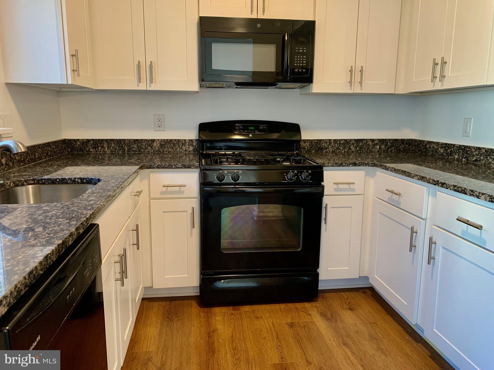 1029 North York Road Road, Unit D Willow Grove, PA 19090 - Photo 9 of 12 a kitchen with granite countertop white cabinets and appliances