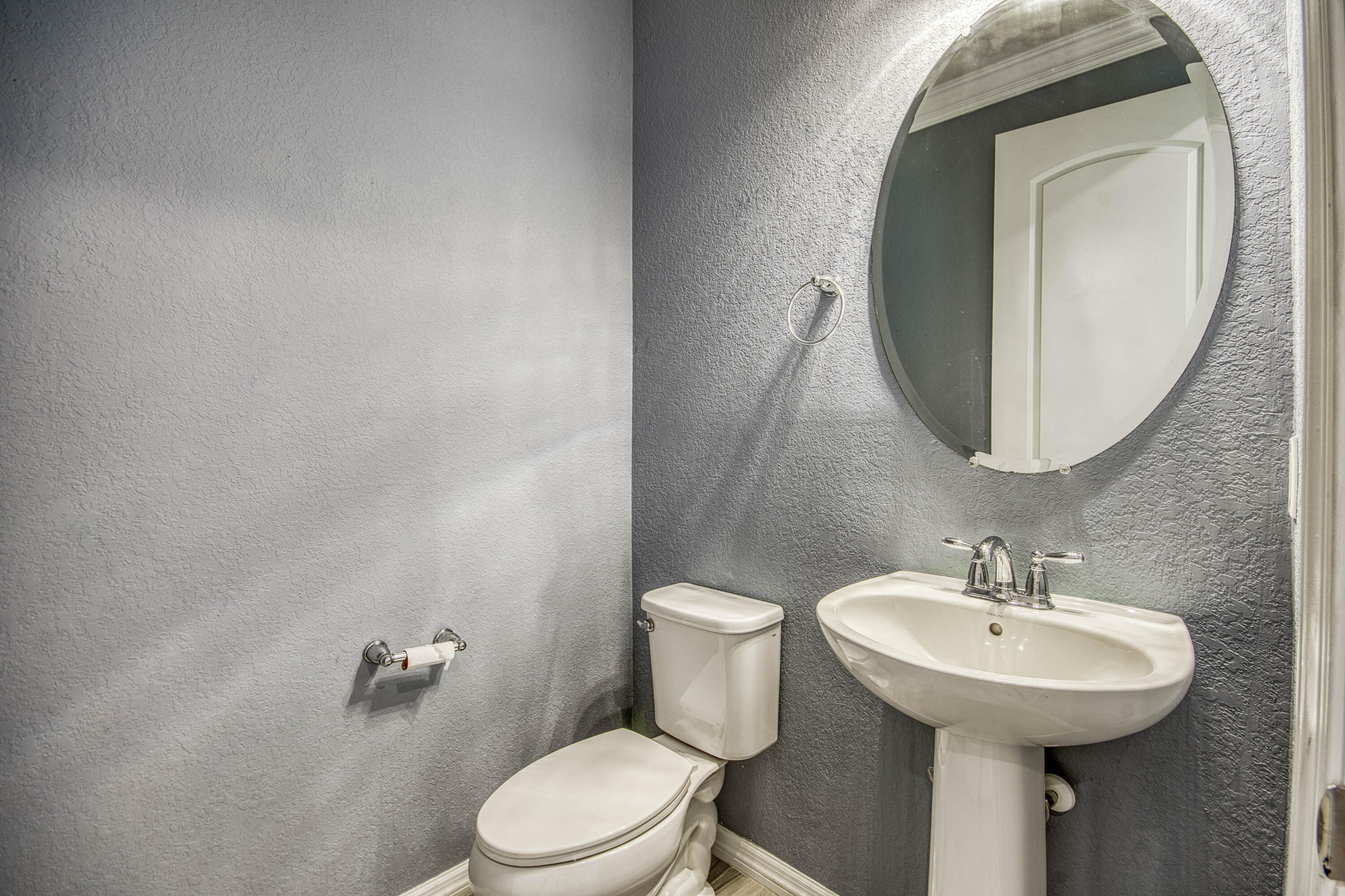 8301 Rearing Lane Lake Worth, FL 33467 - Photo 19 of 33 a bathroom with a toilet sink and mirror