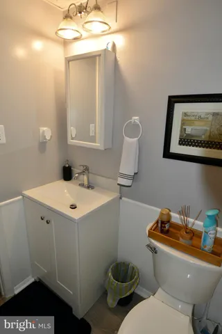 a bathroom with a toilet sink and mirror