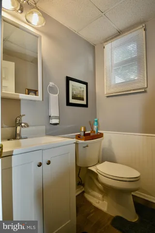 a bathroom with a toilet a sink and mirror