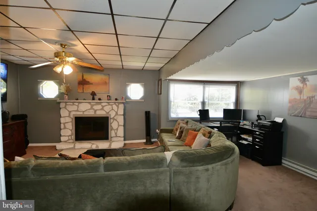 a living room with fireplace furniture and a flat screen tv