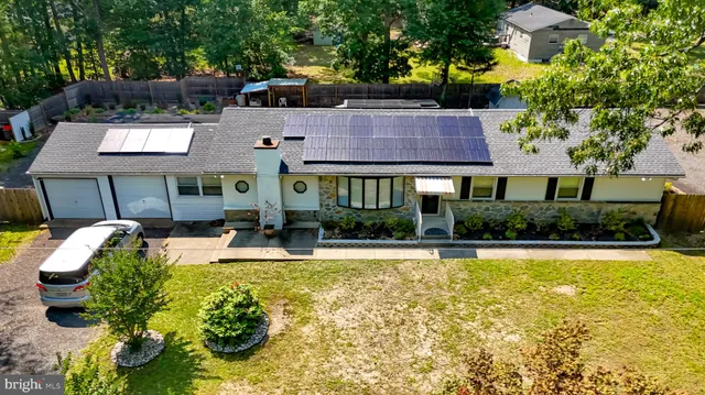 a view of house with outdoor space and swimming pool