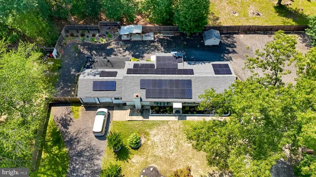 an aerial view of residential house with outdoor space and swimming pool