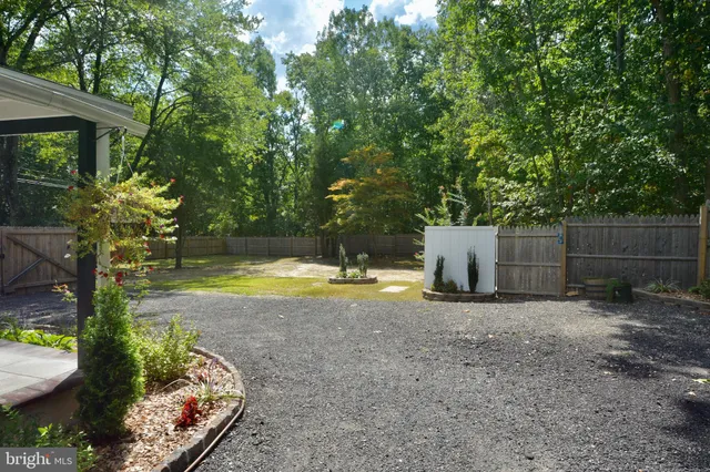 a view of backyard with swimming pool and seating space