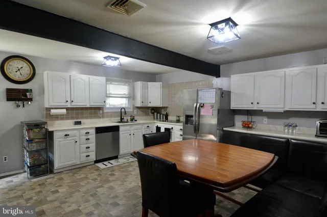 a kitchen with a stove a refrigerator and a sink