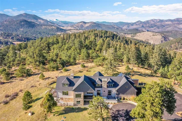 an aerial view of residential houses with a outdoor space and mountain view