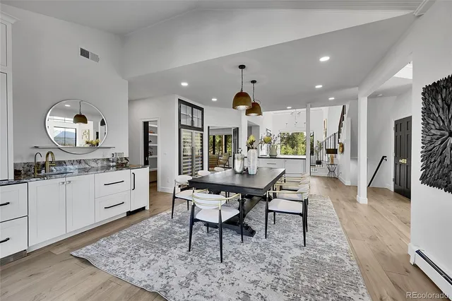 a view of a kitchen with dining table and chairs