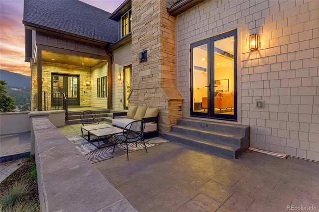 a building outdoor space with patio furniture and glass windows
