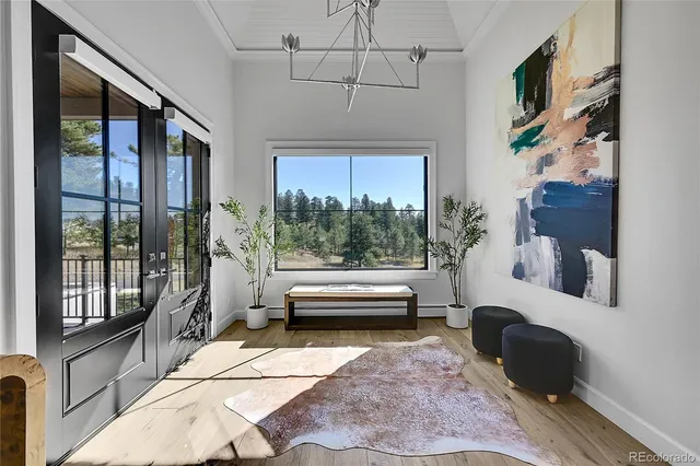 a bathroom with a tub and a large window
