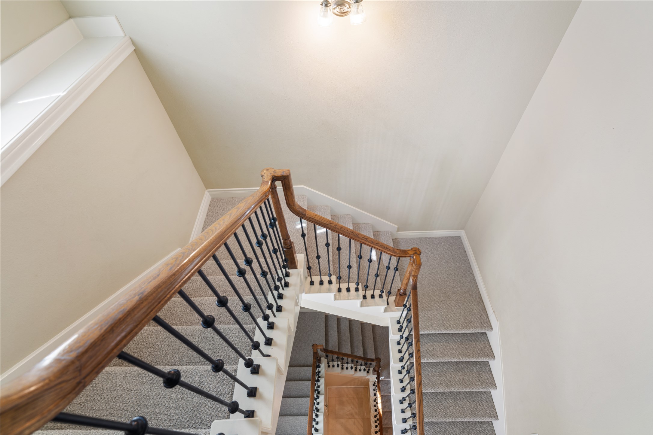 2830 Sherwin Street Houston, TX 77007 - Photo 15 of 26 Pretty staircase with iron rails and NEW (2026) carpet.