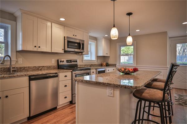 34 Ipswich Road Topsfield, MA 01983 - Photo 5 of 27 a kitchen with stainless steel appliances granite countertop a sink a stove a microwave a center island and cabinets