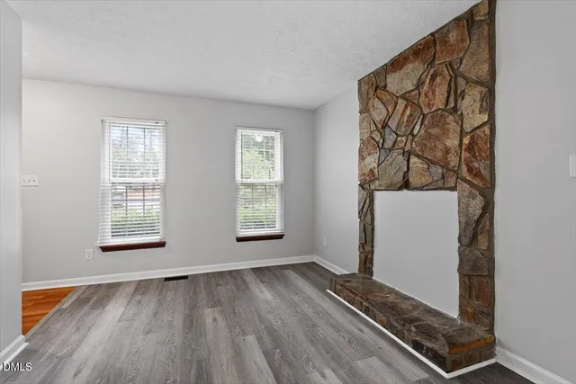 a view of a room with wooden floor and a window
