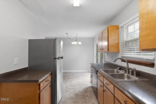 a kitchen that has a sink and a refrigerator