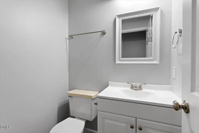 a bathroom with a sink mirror and toilet
