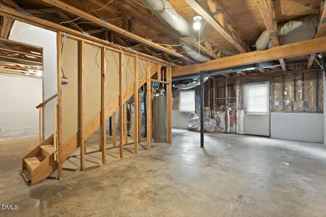 a view of an empty room with wooden floor and windows