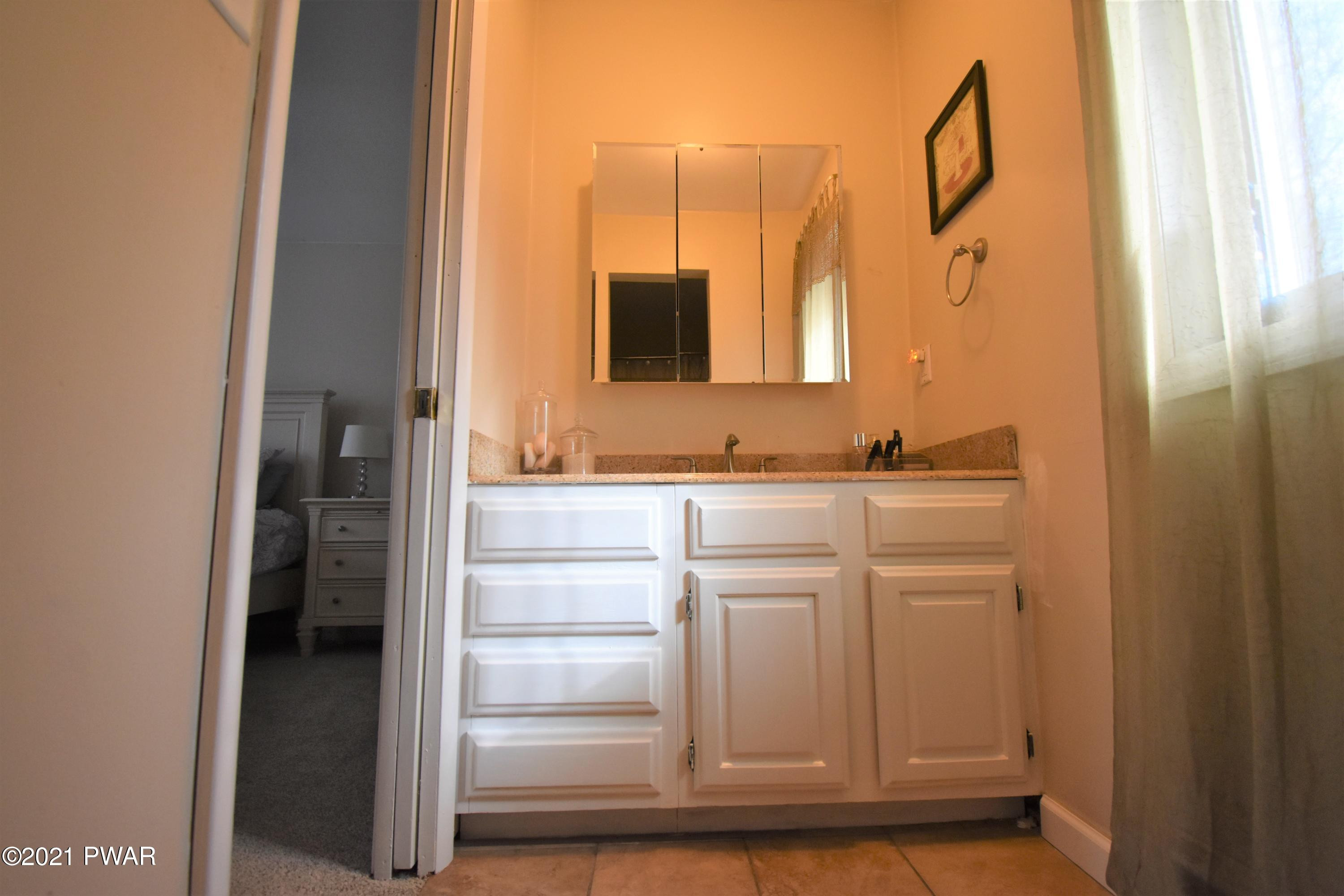 244 Fox Road Dingmans Ferry, PA 18328 - Photo 23 of 31 a bathroom with a sink and a mirror