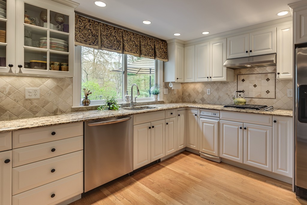 15 Cox Road Winchester, MA 01890 - Photo 11 of 27 a kitchen with granite countertop white cabinets and window