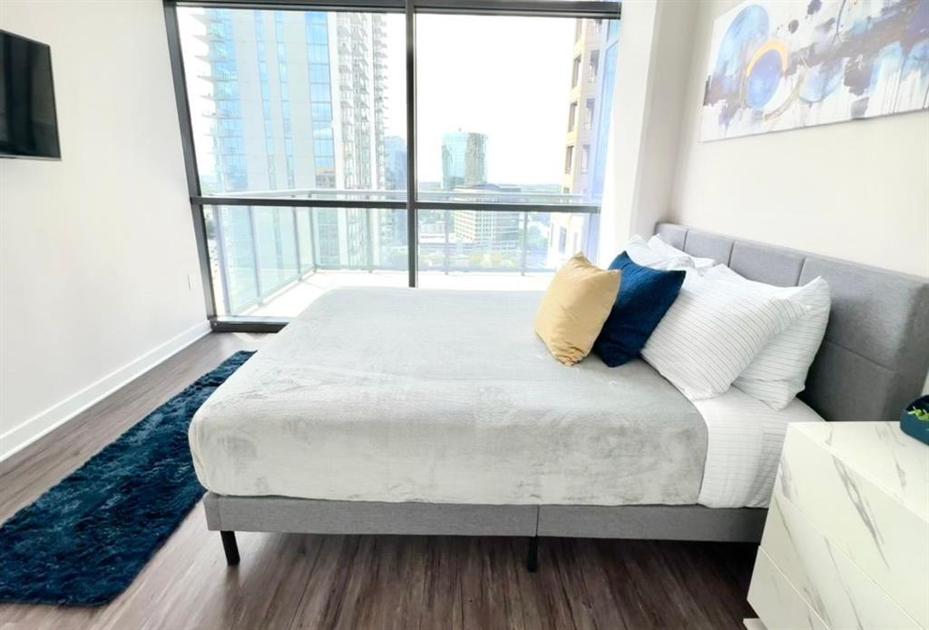 3382 Peachtree Road Northeast, Unit S08 Atlanta, GA 30326 - Photo 11 of 52 a large bed sitting in a bedroom next to a window