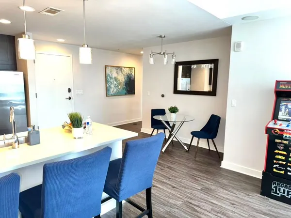 a view of a dining room with furniture and wooden floor