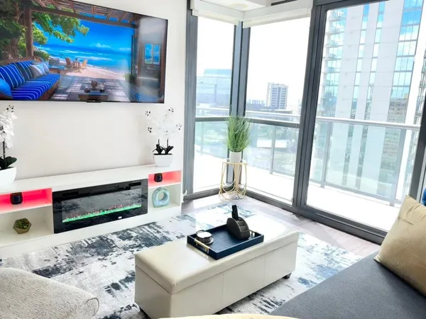 a living room with furniture and a floor to ceiling window
