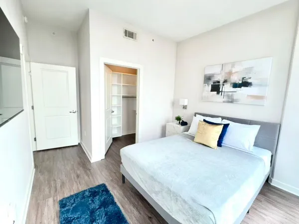 a bedroom with a bed and painting on the wall