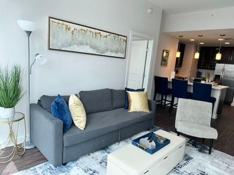 3382 Peachtree Road Northeast, Unit S08 Atlanta, GA 30326 - Photo 15 of 52 a living room with furniture and wooden floor