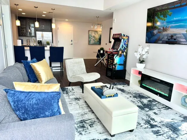 a living room with furniture and wooden floor