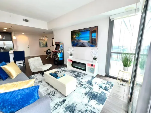 a bedroom with a bed a couch and a window