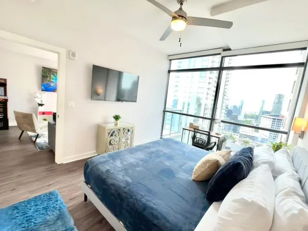 a living room with furniture rug and wooden floor