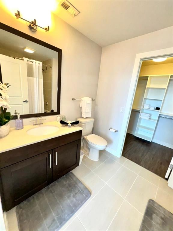 3382 Peachtree Road Northeast, Unit S08 Atlanta, GA 30326 - Photo 26 of 52 a spacious bathroom with a double vanity sink a mirror and a toilet