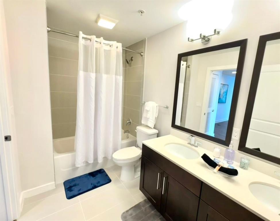 3382 Peachtree Road Northeast, Unit S08 Atlanta, GA 30326 - Photo 31 of 52 a bathroom with a sink and a mirror