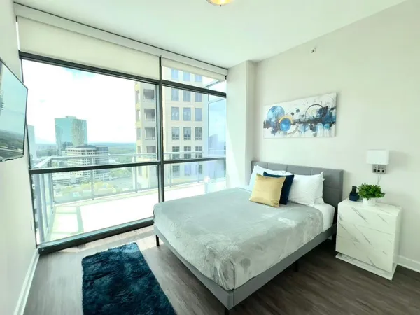 a bedroom with a bed and a wooden floor