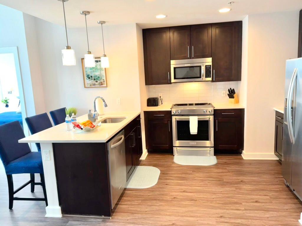 3382 Peachtree Road Northeast, Unit S08 Atlanta, GA 30326 - Photo 4 of 52 a kitchen with stainless steel appliances a stove a sink and a refrigerator