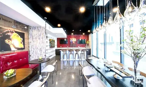 a living room with lots of furniture and chandelier