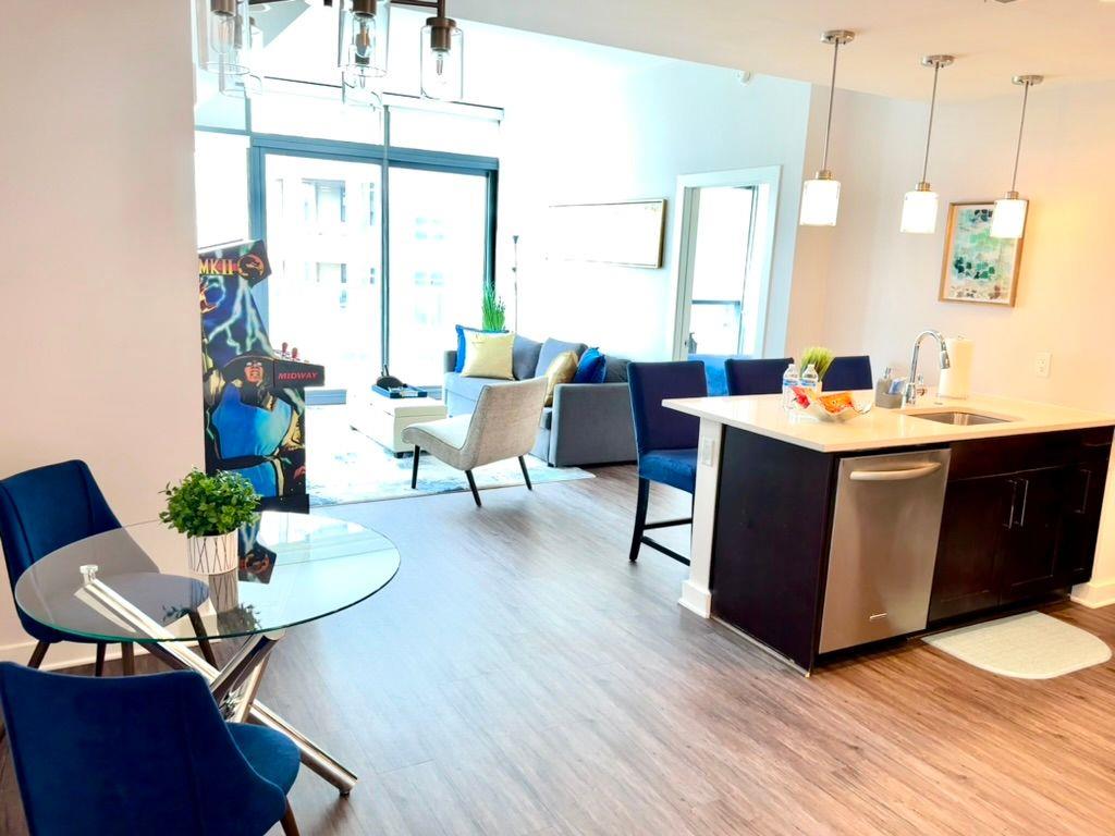3382 Peachtree Road Northeast, Unit S08 Atlanta, GA 30326 - Photo 7 of 52 a view of a dining room with furniture a chandelier and wooden floor