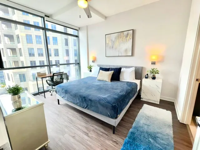 a bedroom with a large bed and a large window