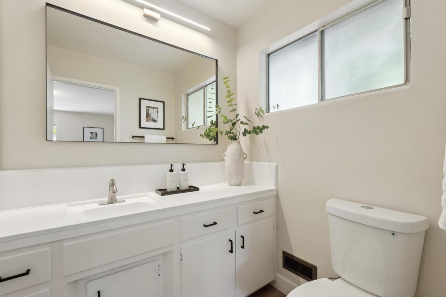 755 Santa Rita Avenue Los Altos, CA 94022 - Photo 31 of 50 a bathroom with a sink a toilet and a mirror