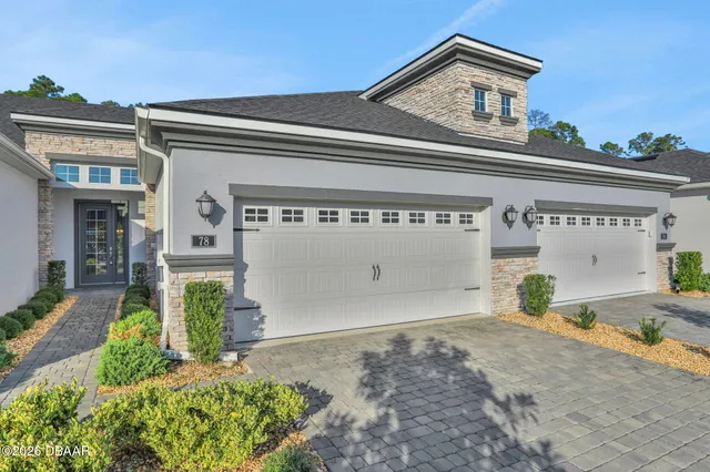 a kitchen with granite countertop a sink a refrigerator and cabinets