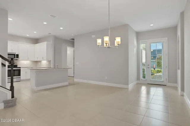 a bathroom with double vanity sinks a vanity a lamp and a mirror