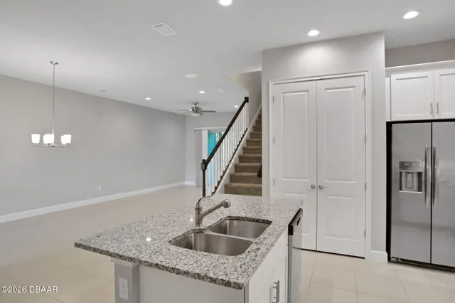 a view of a house with backyard and a tree