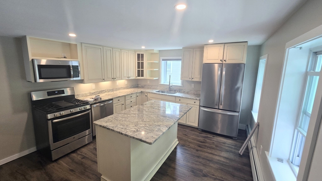 15 Central Street, Unit 4 Georgetown, MA 01833 - Photo 2 of 24 a kitchen with a refrigerator sink and microwave