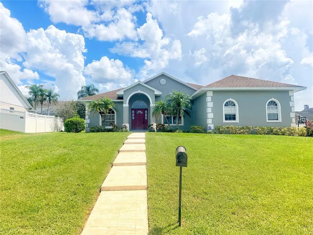a front view of house with yard and green space