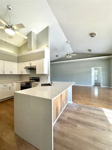 a large white kitchen with cabinets